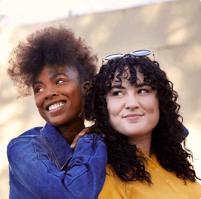 two women smiling, blue jacket and yellow shirt