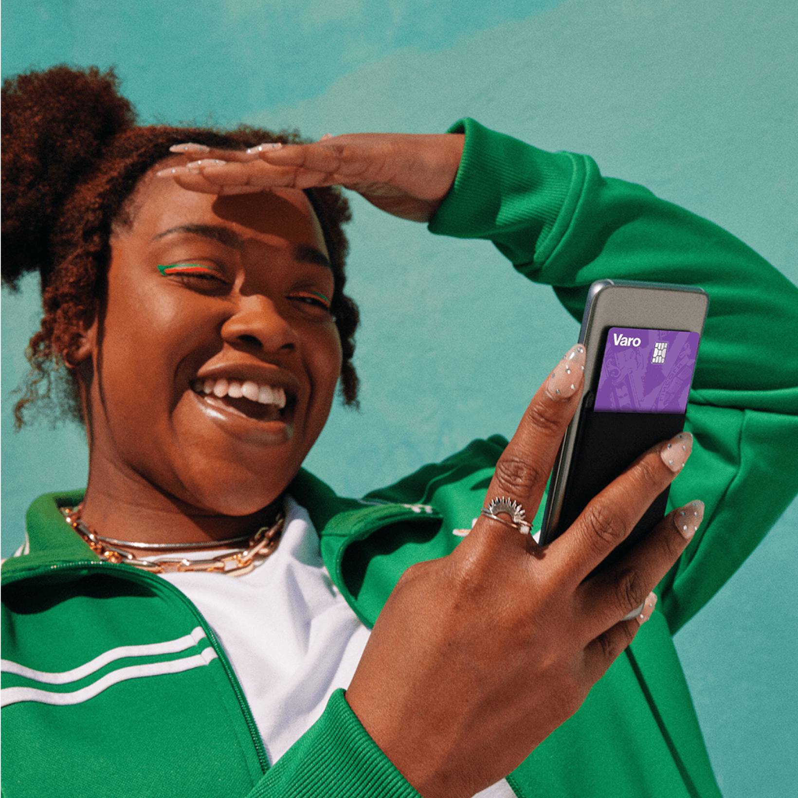 Girl in green checking Varo app.png