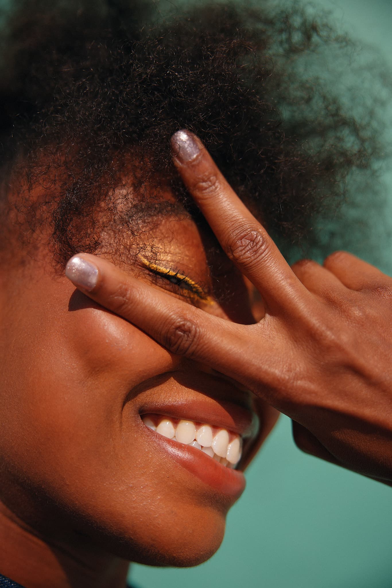 woman with peace sign over her eyes (1366 × 2048)